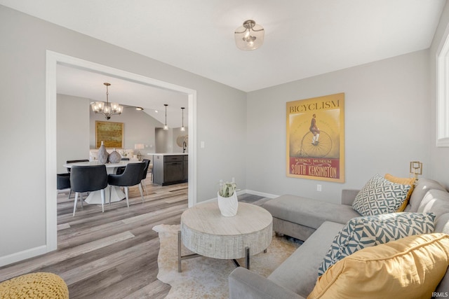 5165 Greyson Heights Dr, Auburn, IN 46706 - living room featuring light wood-type flooring and a chandelier