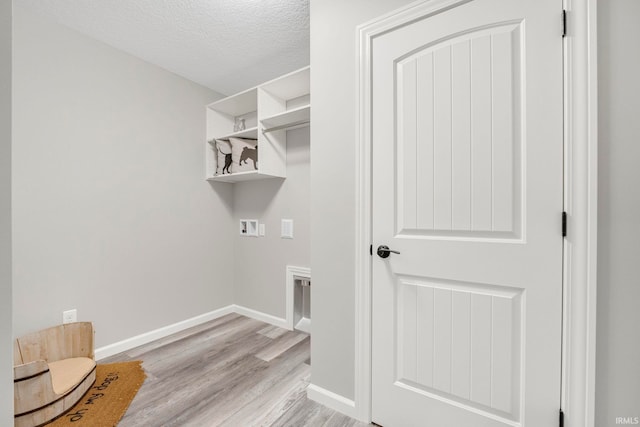 5165 Greyson Heights Dr, Auburn, IN 46706 - laundry area with hookup for a washing machine, light wood-style floors, and a textured ceiling
