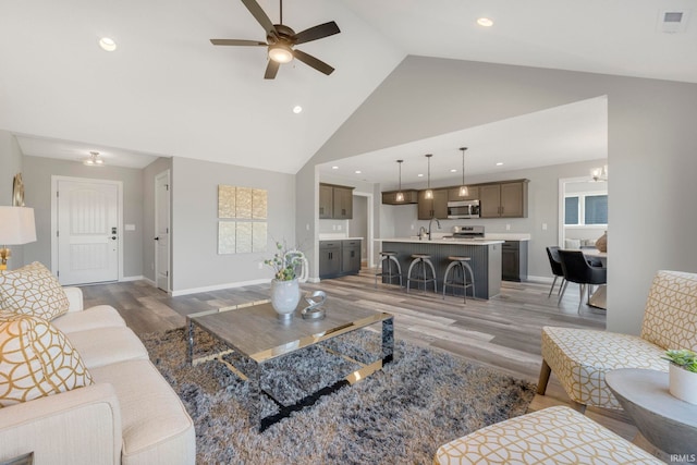 5165 Greyson Heights Dr, Auburn, IN 46706 - living area with light wood-type flooring, ceiling fan, high vaulted ceiling, and recessed lighting