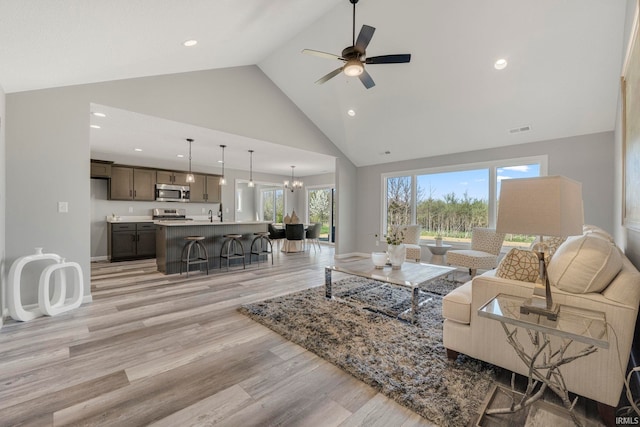 5165 Greyson Heights Dr, Auburn, IN 46706 - living room featuring high vaulted ceiling, light wood finished floors, ceiling fan, recessed lighting, and a chandelier