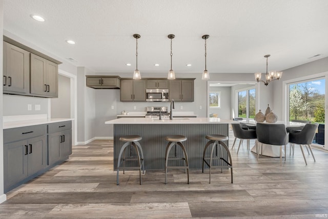 5165 Greyson Heights Dr, Auburn, IN 46706 - kitchen featuring stainless steel appliances, a chandelier, light wood finished floors, light countertops, and recessed lighting