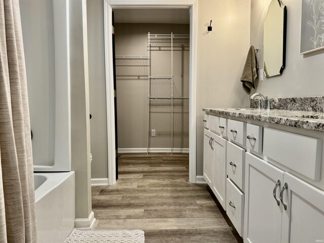 391 Hel Mar Dr, Mitchell, IN 47446 - bathroom featuring vanity, wood finished floors, and bathtub / shower combination