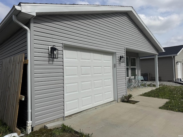 391 Hel Mar Dr, Mitchell, IN 47446 - garage featuring covered porch and concrete driveway