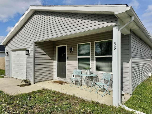 391 Hel Mar Dr, Mitchell, IN 47446 - view of front facade featuring an attached garage and a porch