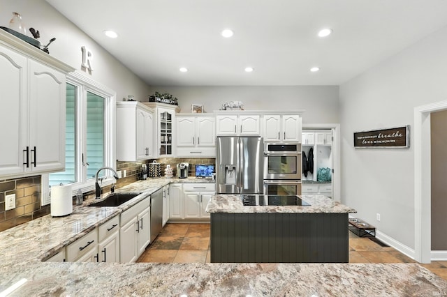 17325 N State Road 1st Rd, Spencerville, IN 46788 - kitchen with stainless steel appliances, tasteful backsplash, light stone countertops, glass insert cabinets, and recessed lighting