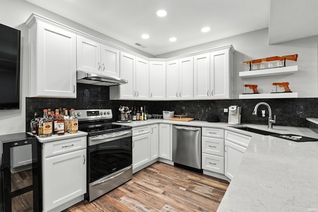 17325 N State Road 1st Rd, Spencerville, IN 46788 - kitchen featuring appliances with stainless steel finishes, wine cooler, recessed lighting, under cabinet range hood, and white cabinetry