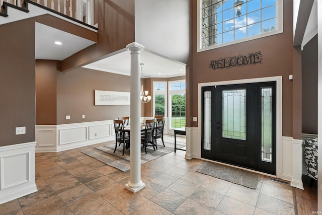 17325 N State Road 1st Rd, Spencerville, IN 46788 - foyer with a towering ceiling, a chandelier, decorative columns, wainscoting, and a decorative wall
