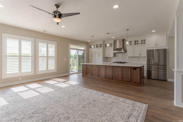 2843 Alex Ct, Newburgh, IN 47630 - kitchen featuring stainless steel appliances, wall chimney range hood, dark wood-style floors, decorative backsplash, and ceiling fan