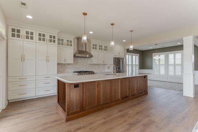 2843 Alex Ct, Newburgh, IN 47630 - kitchen with wall chimney exhaust hood, high quality fridge, light countertops, light wood finished floors, and a large island