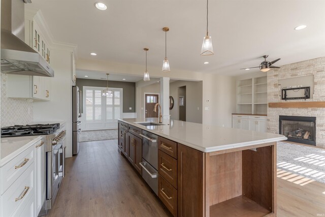 2843 Alex Ct, Newburgh, IN 47630 - kitchen featuring wall chimney exhaust hood, appliances with stainless steel finishes, wood finished floors, white cabinets, and recessed lighting