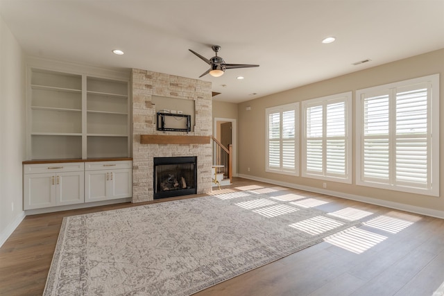 2843 Alex Ct, Newburgh, IN 47630 - unfurnished living room with wood finished floors, ceiling fan, a fireplace, recessed lighting, and built in features