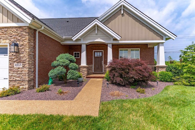 2843 Alex Ct, Newburgh, IN 47630 - view of front of property featuring stone siding, board and batten siding, a shingled roof, brick siding, and a porch