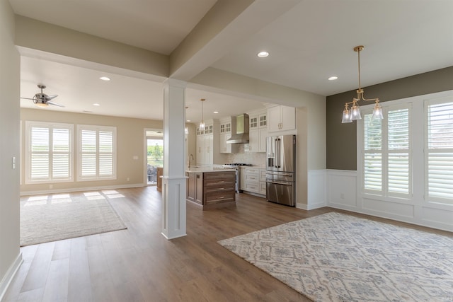 2843 Alex Ct, Newburgh, IN 47630 - kitchen with high end fridge, open floor plan, wall chimney range hood, light countertops, and glass insert cabinets