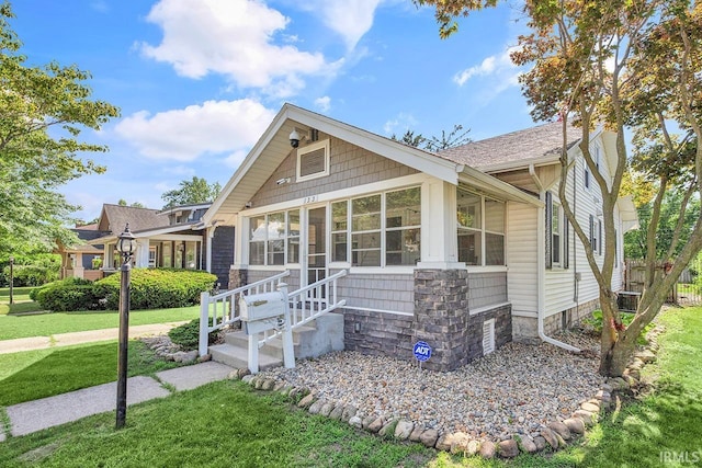 133 Crescent St, Elkhart, IN 46516 - view of front of house featuring a front lawn, entry steps, and a shingled roof