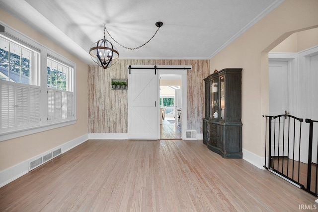 133 Crescent St, Elkhart, IN 46516 - unfurnished dining area featuring wood finished floors, a barn door, a chandelier, and ornamental molding