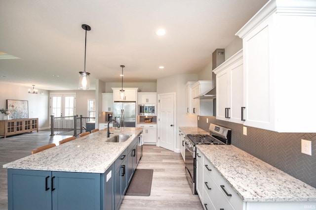 5358 Maize Dr, West Lafayette, IN 47906 - kitchen with stainless steel appliances, wall chimney range hood, light wood-type flooring, backsplash, and blue cabinetry