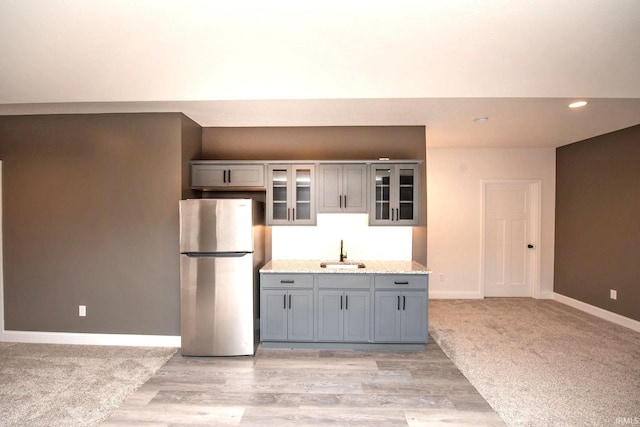5358 Maize Dr, West Lafayette, IN 47906 - kitchen with freestanding refrigerator, gray cabinetry, glass insert cabinets, light wood-type flooring, and recessed lighting