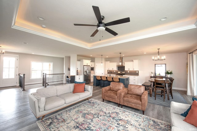 5358 Maize Dr, West Lafayette, IN 47906 - living area featuring a raised ceiling, a chandelier, a ceiling fan, wood finished floors, and recessed lighting