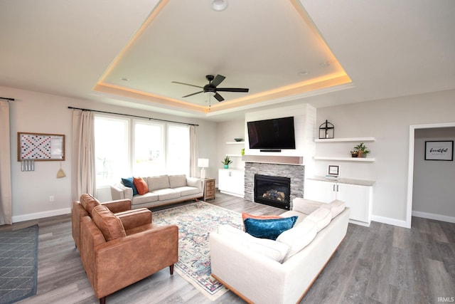 5358 Maize Dr, West Lafayette, IN 47906 - living room with a tray ceiling, ceiling fan, dark wood-style floors, and a fireplace