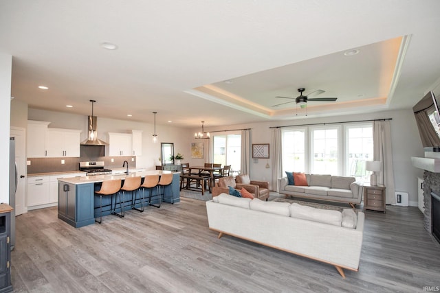 5358 Maize Dr, West Lafayette, IN 47906 - living area featuring a tray ceiling, ceiling fan, light wood-style floors, and recessed lighting