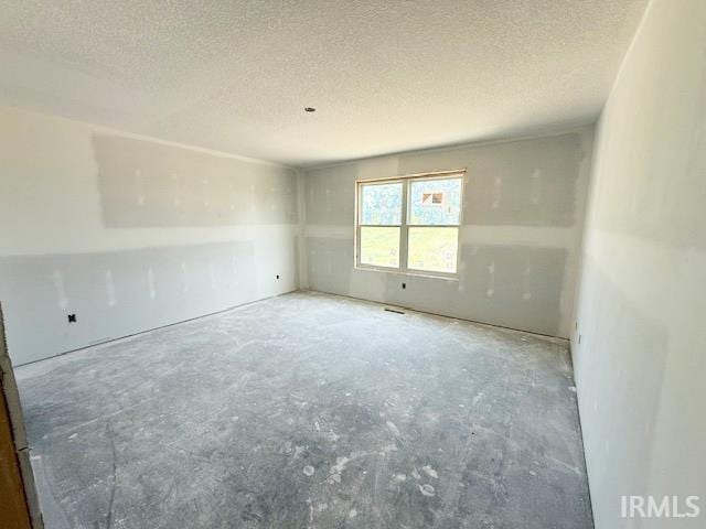 13315 Halen Hill Ct, Fort Wayne, IN 46818 - empty room featuring concrete floors and a textured ceiling