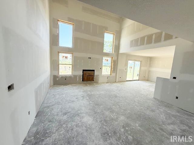 13315 Halen Hill Ct, Fort Wayne, IN 46818 - unfurnished living room featuring a high ceiling and concrete flooring
