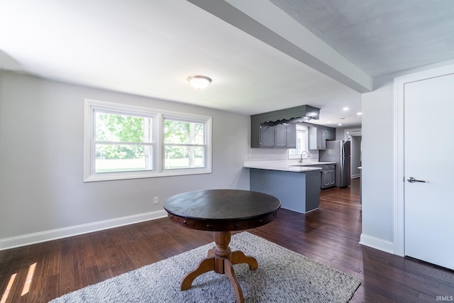 6321 Butt Rd, Fort Wayne, IN 46818 - kitchen with freestanding refrigerator, light countertops, gray cabinetry, dark wood-style flooring, and a peninsula