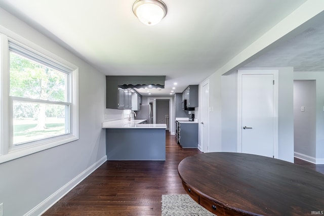 6321 Butt Rd, Fort Wayne, IN 46818 - kitchen featuring light countertops, a peninsula, dark wood finished floors, and freestanding refrigerator