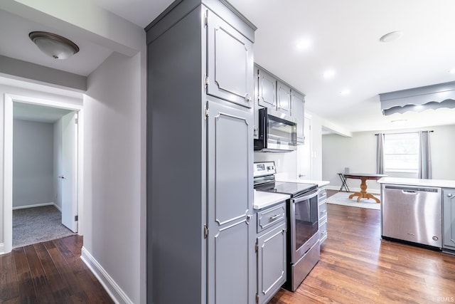 6321 Butt Rd, Fort Wayne, IN 46818 - kitchen with stainless steel appliances, dark wood-style floors, light countertops, gray cabinets, and recessed lighting