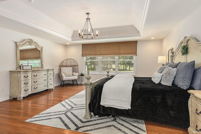 8196 E Walnut Rdg, New Carlisle, IN 46552 - bedroom featuring a raised ceiling, a chandelier, multiple windows, and wood finished floors
