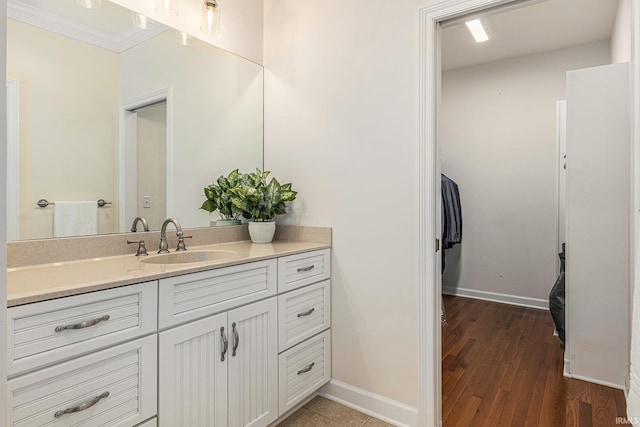 8196 E Walnut Rdg, New Carlisle, IN 46552 - bathroom featuring crown molding, vanity, and wood finished floors