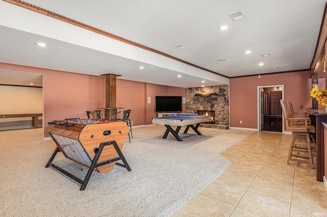 8196 E Walnut Rdg, New Carlisle, IN 46552 - game room with recessed lighting, crown molding, light colored carpet, a stone fireplace, and light tile patterned floors