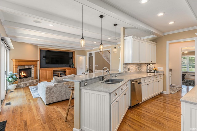8196 E Walnut Rdg, New Carlisle, IN 46552 - kitchen with stainless steel dishwasher, light wood-style flooring, white cabinetry, a peninsula, and beamed ceiling