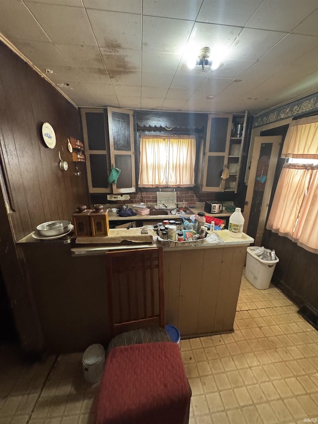 527 E Leith St, Fort Wayne, IN 46806 - kitchen with light flooring and wood walls