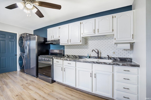 8 Emerald Ln, Huntington, IN 46750 - kitchen with stacked washer and clothes dryer, appliances with stainless steel finishes, under cabinet range hood, dark countertops, and light wood-style flooring