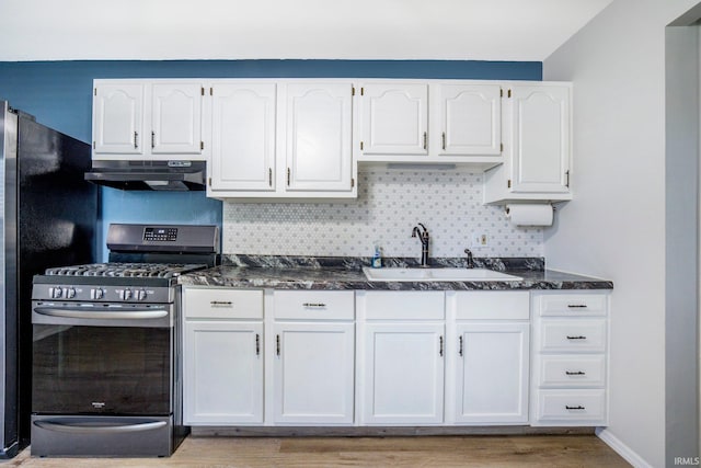 8 Emerald Ln, Huntington, IN 46750 - kitchen featuring stainless steel range with gas stovetop, under cabinet range hood, white cabinetry, and tasteful backsplash