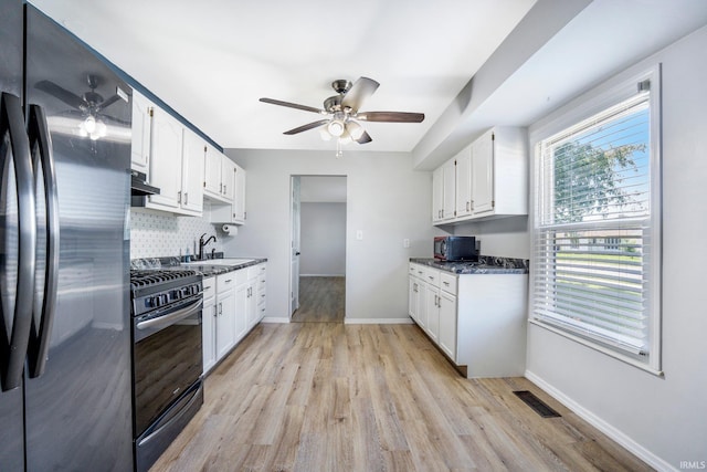 8 Emerald Ln, Huntington, IN 46750 - kitchen with freestanding refrigerator, stainless steel gas range oven, ceiling fan, black microwave, and light wood-type flooring