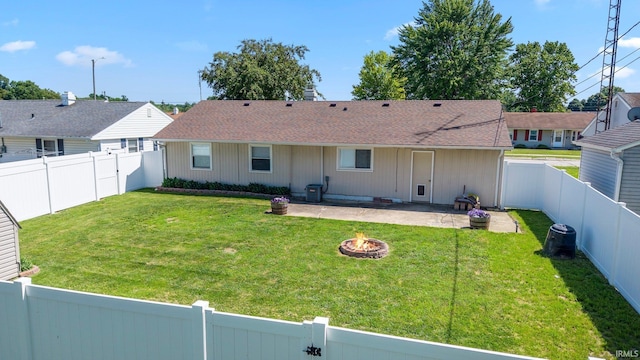 8 Emerald Ln, Huntington, IN 46750 - rear view of house featuring a fire pit, a patio area, a fenced backyard, and a shingled roof