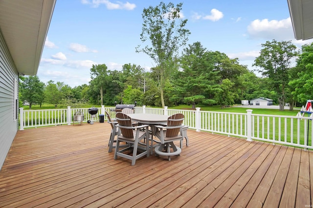 7316 Butt Rd, Fort Wayne, IN 46818 - wooden deck featuring outdoor dining area, a lawn, and view of wooded area