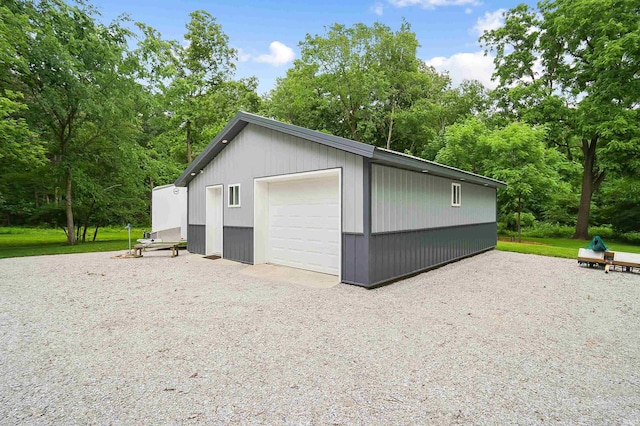 7316 Butt Rd, Fort Wayne, IN 46818 - detached garage with driveway and view of wooded area