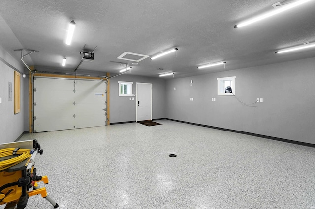 7316 Butt Rd, Fort Wayne, IN 46818 - garage featuring a garage door opener and baseboards