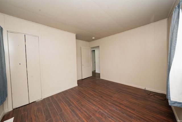 221 S Kenmore St, South Bend, IN 46619 - unfurnished bedroom featuring dark wood-type flooring and a closet