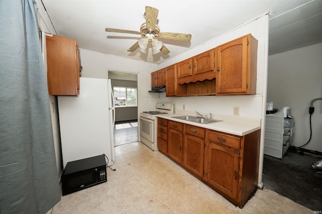 221 S Kenmore St, South Bend, IN 46619 - kitchen with white appliances, under cabinet range hood, ceiling fan, light countertops, and brown cabinetry