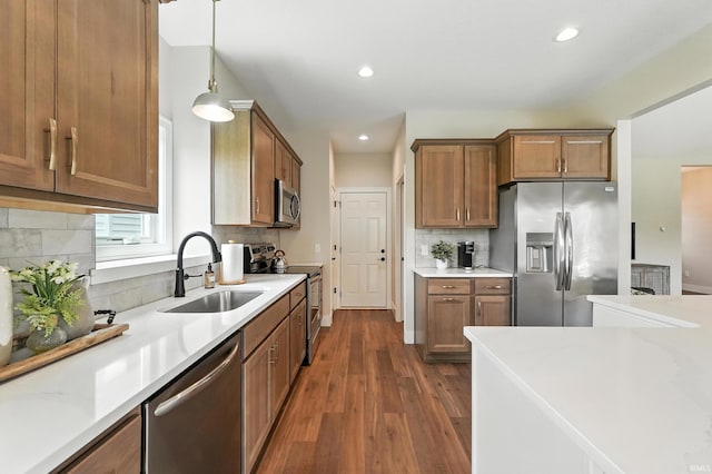 1381 Codorna Cv, Fort Wayne, IN 46804 - kitchen with appliances with stainless steel finishes, decorative backsplash, dark wood-style floors, light countertops, and recessed lighting