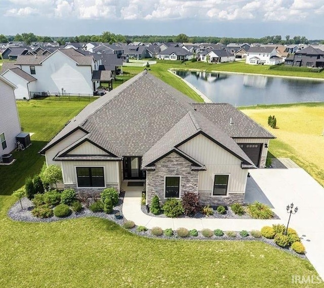 936 Switchfoot Dr, Huntertown, IN 46748 - view of front facade featuring stone siding, board and batten siding, a residential view, a shingled roof, and a front lawn