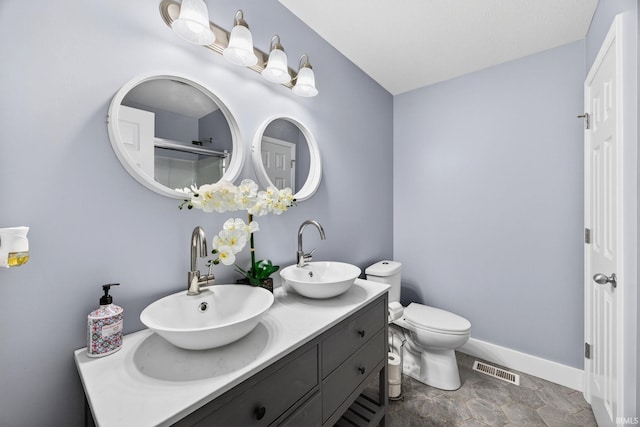 4310 Ashard Dr, South Bend, IN 46628 - bathroom featuring double vanity and baseboards