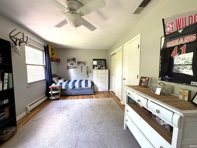 1896 N Michael Dr, Marion, IN 46952 - bedroom with baseboard heating, wood finished floors, and a ceiling fan