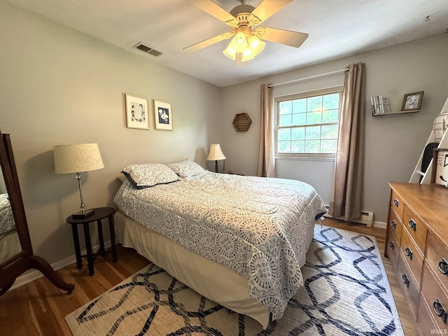 1896 N Michael Dr, Marion, IN 46952 - bedroom featuring light wood-type flooring, ceiling fan, and a baseboard radiator