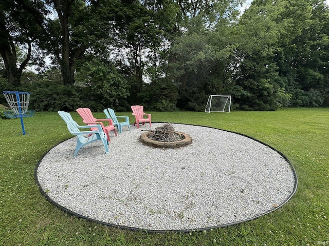 1896 N Michael Dr, Marion, IN 46952 - view of green lawn featuring an outdoor fire pit and view of scattered trees