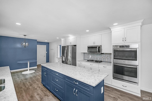 3111 N Eastlake Dr, Elkhart, IN 46514 - kitchen with appliances with stainless steel finishes, blue cabinets, white cabinets, wood finished floors, and recessed lighting